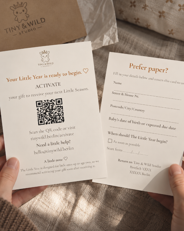 Hands holding Tiny & Wild activation cards showing a QR code and a paper details form beside gift packaging